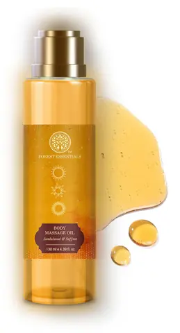 Bottle with a drop of golden oil beside it