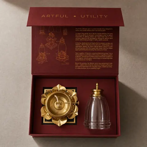 Open gift box showing the brass base and the glass chimney