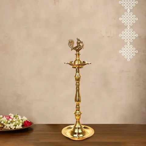 A single brass lamp beside flowers