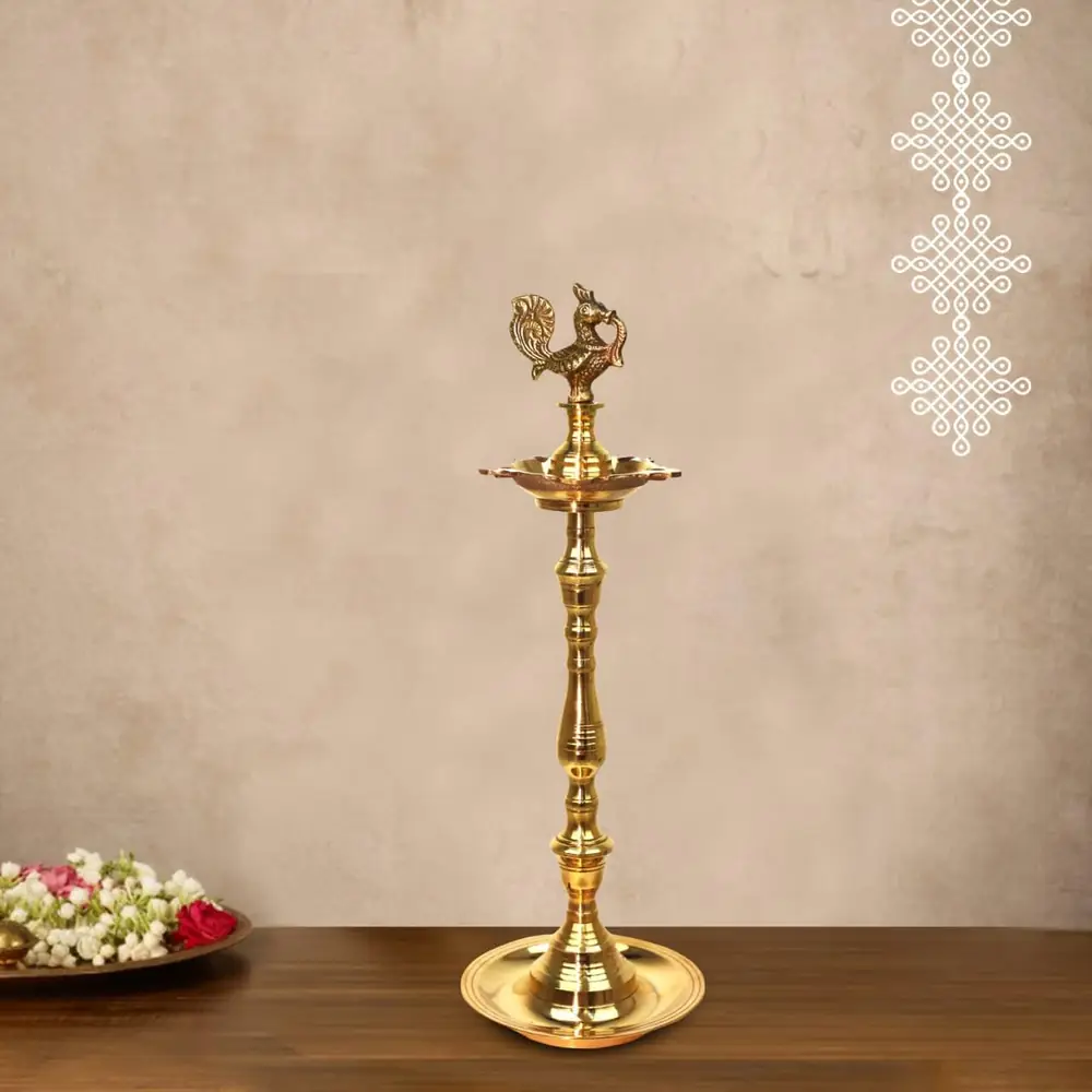A single brass lamp beside flowers