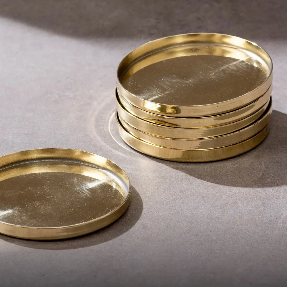Two brass coasters side by side