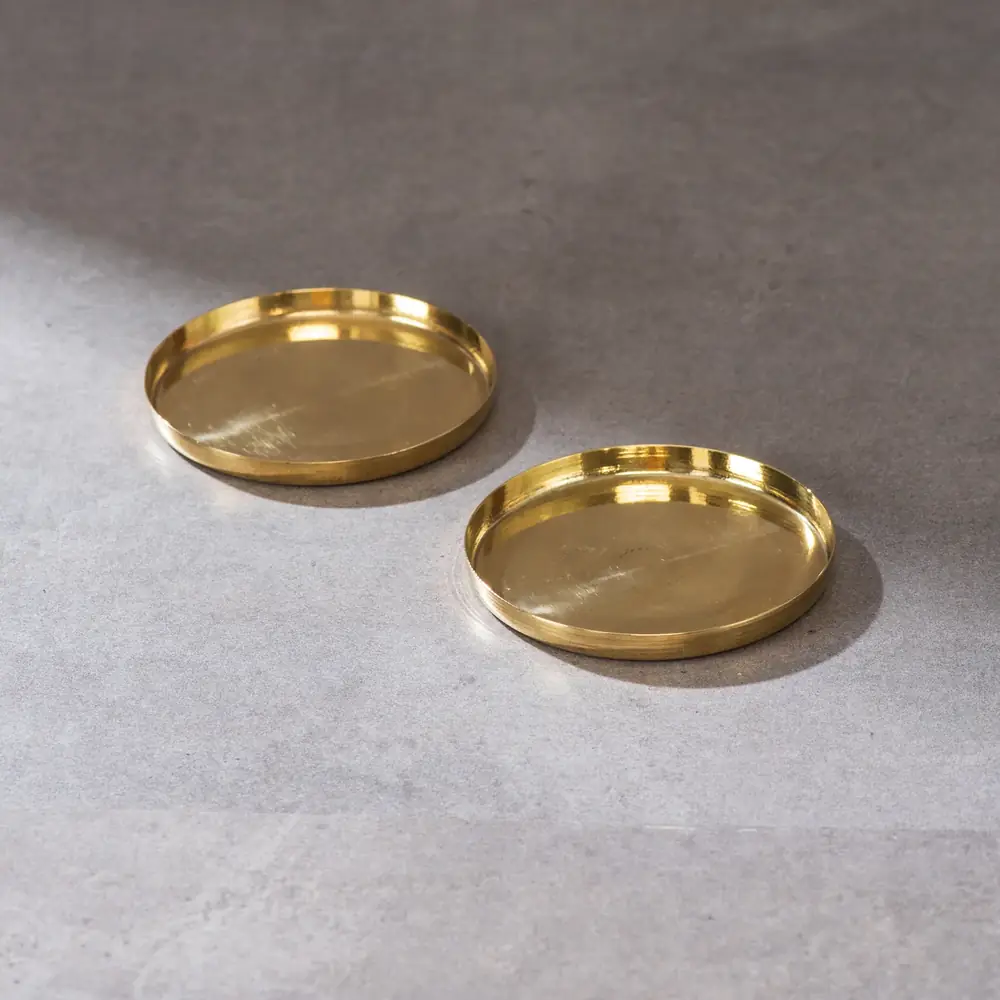 A short stack of brass coasters