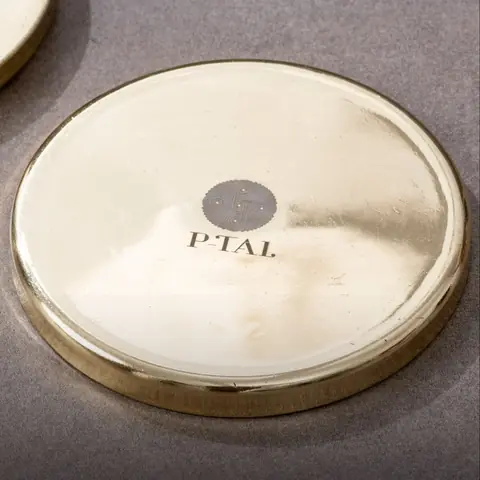 Close view of one coaster with the maker mark