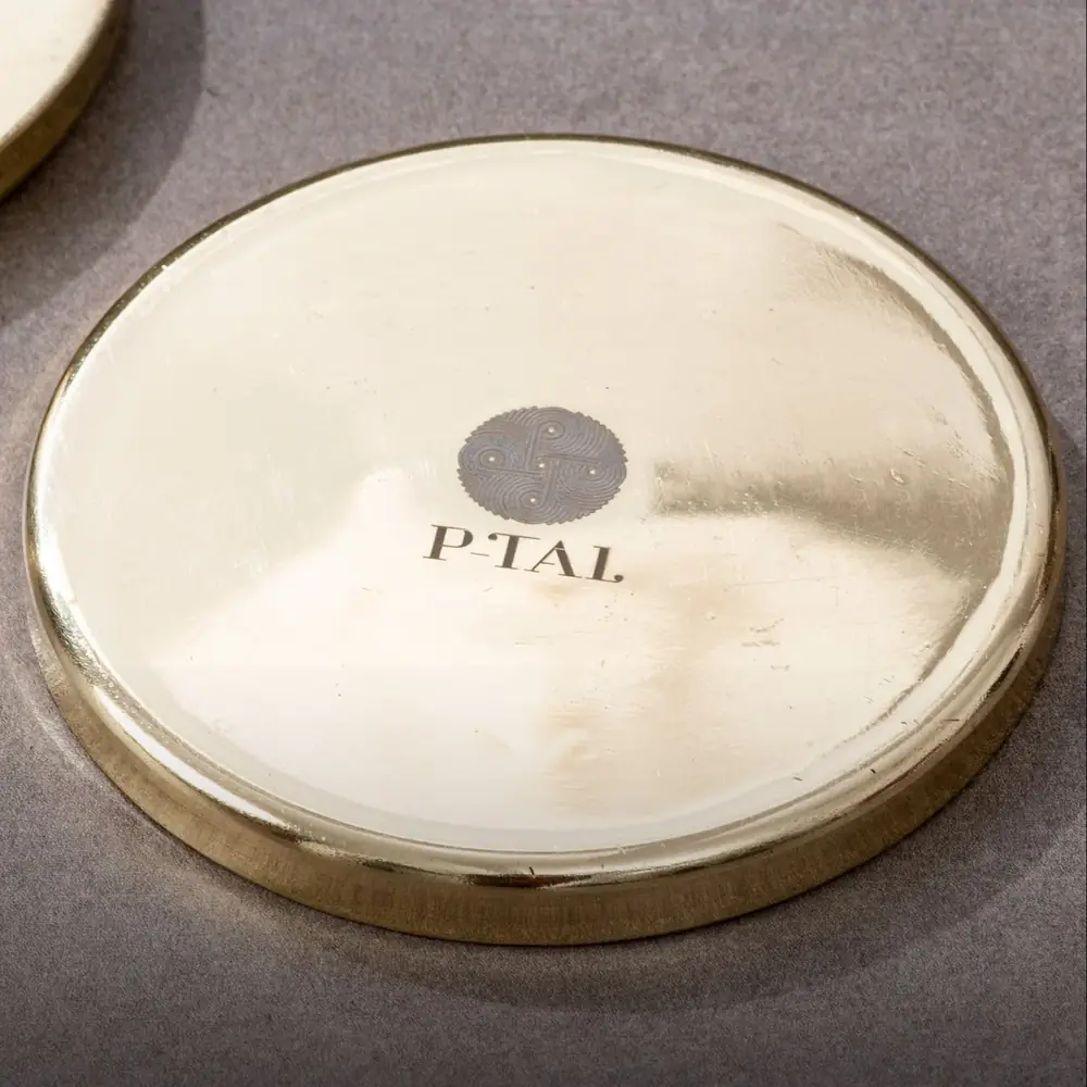 Close view of one coaster with the maker mark