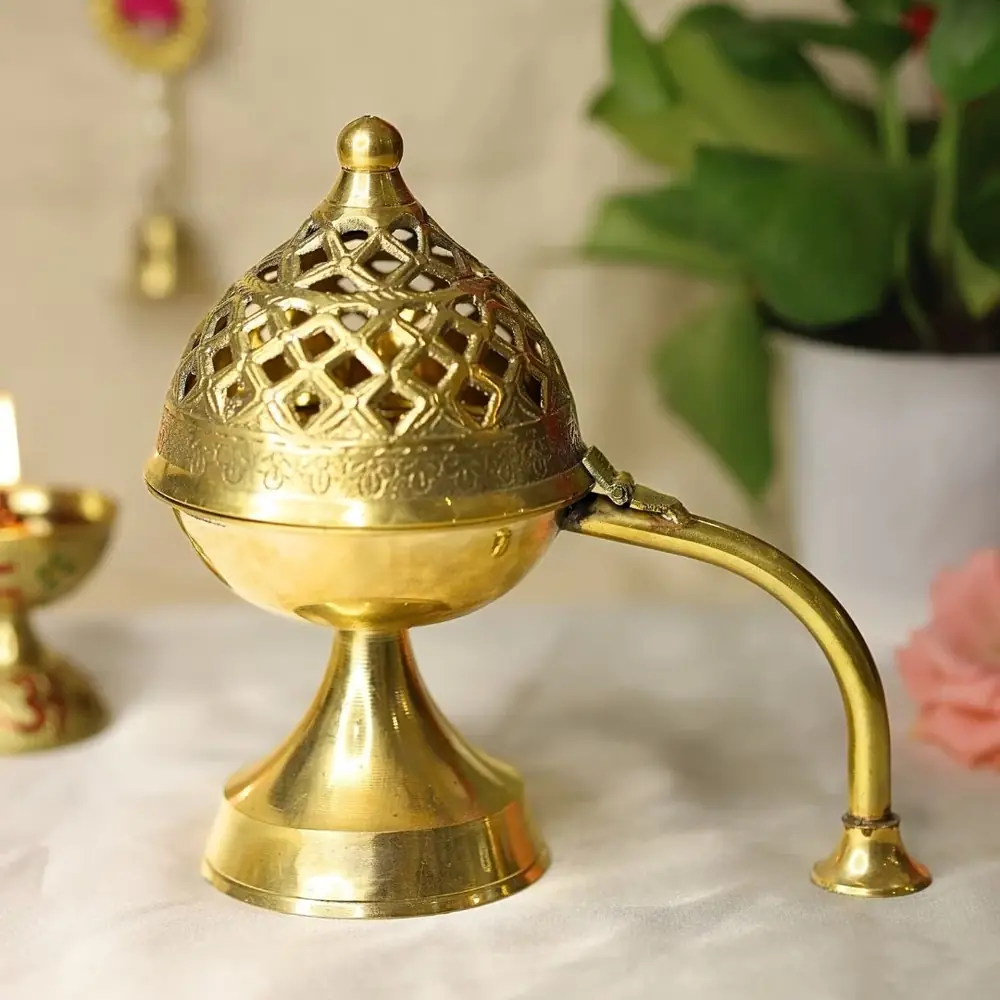 Brass dhoop daan with a pierced dome lid and curved handle
