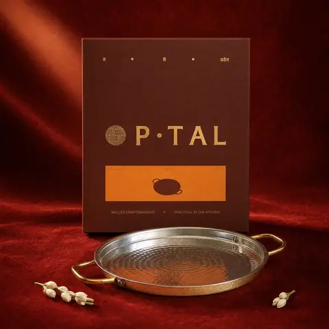 The tawa in front of its box on a red cloth