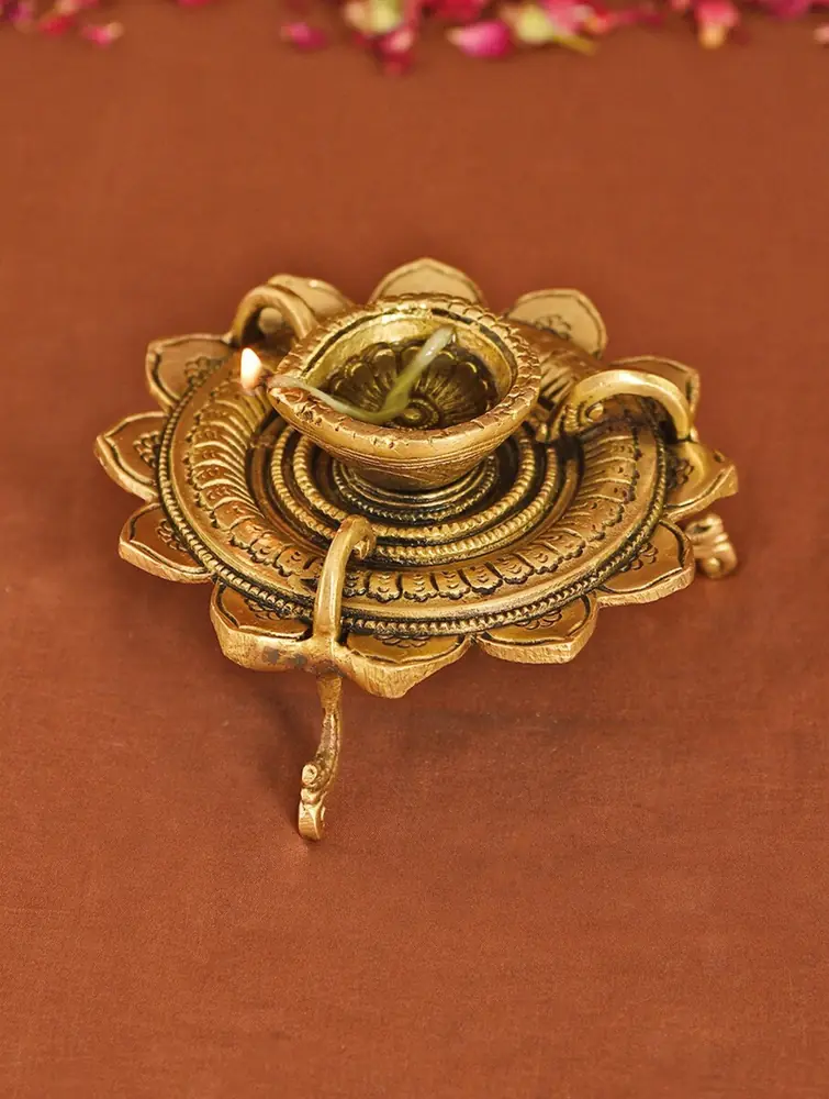 Brass flower-shaped diya seen from above