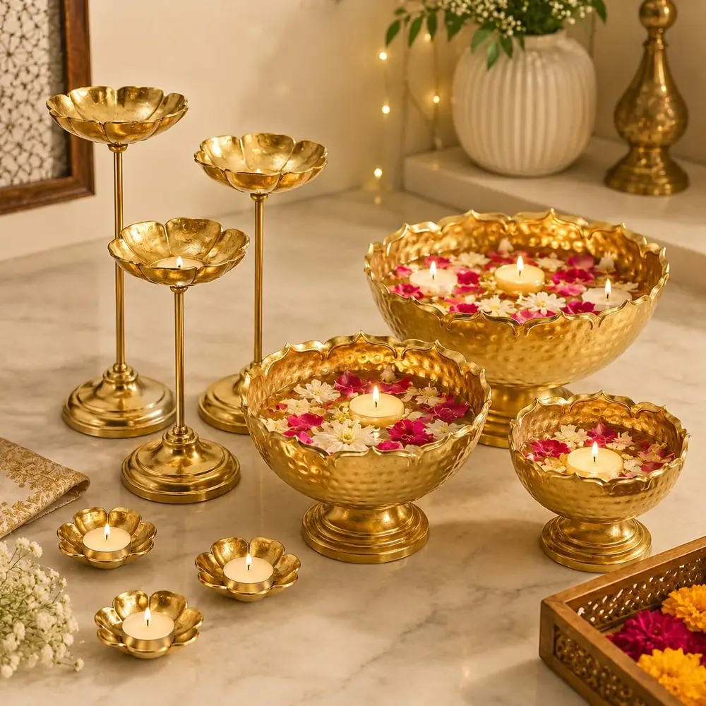 The urli bowls and stands filled with flowers on a marble floor