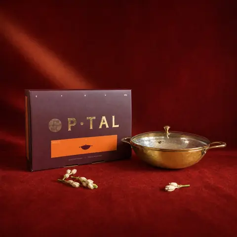 The kadhai and its box on a red cloth