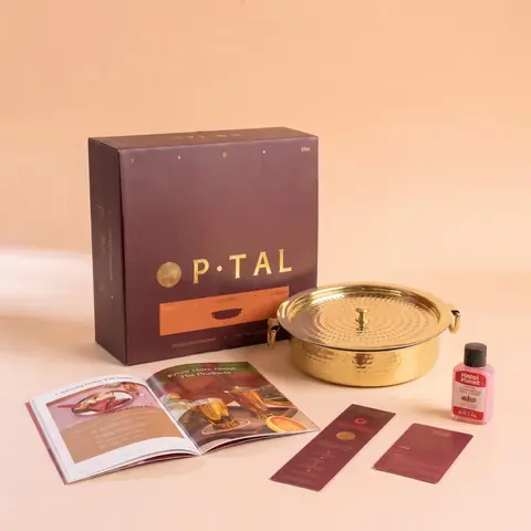 Gift box open with a booklet beside the lagaan