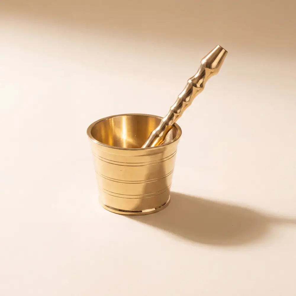 Brass mortar with the pestle standing in it