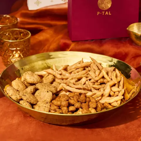 Brass paraat holding snacks on an orange cloth