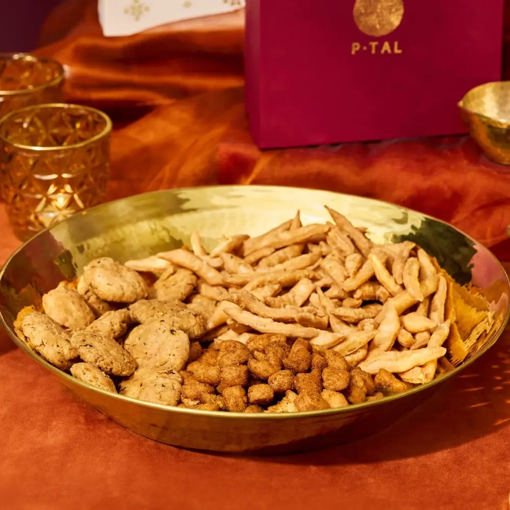 Brass paraat holding snacks on an orange cloth