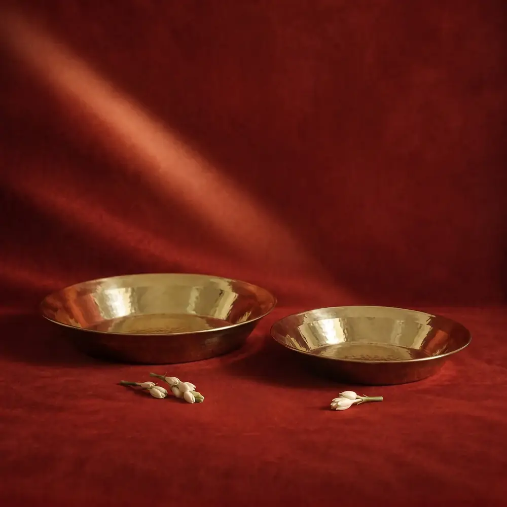 Two brass paraats on a red cloth