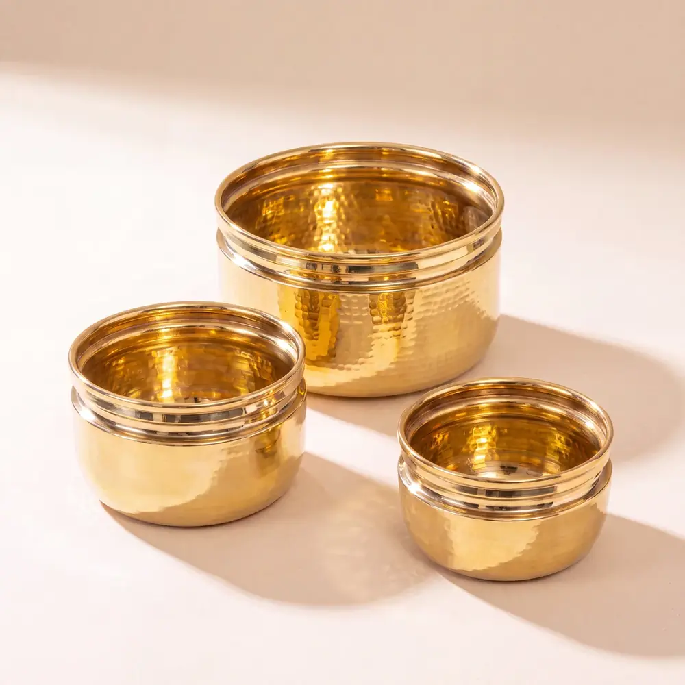Three brass planters in small, medium and large sizes