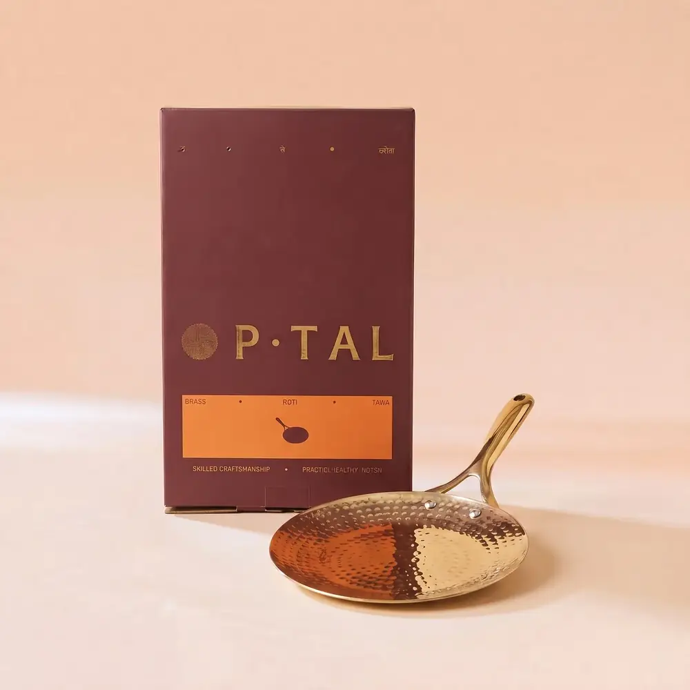 The tawa leaning beside its box on a peach ground