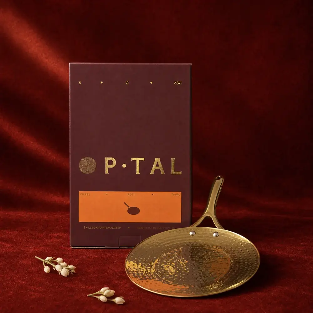 The tawa lying in front of its box on a red cloth