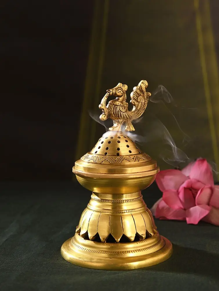 Golden brass lidded piece with a peacock on top