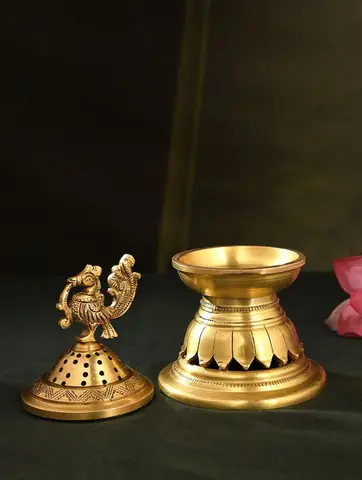 The lid lifted off beside the lotus-petal base