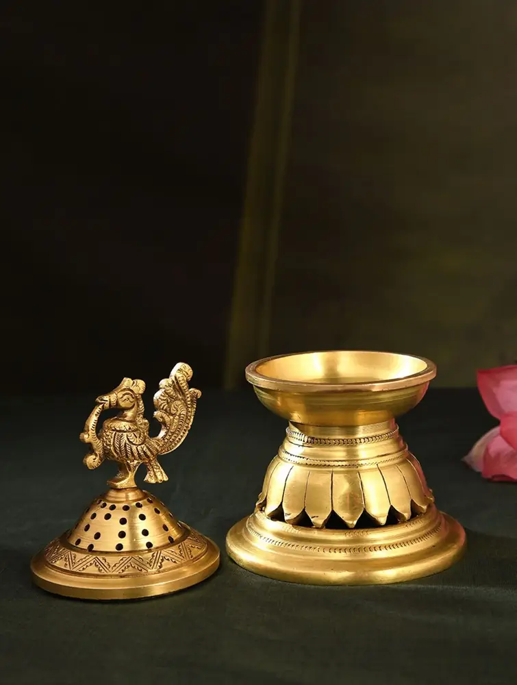 The lid lifted off beside the lotus-petal base