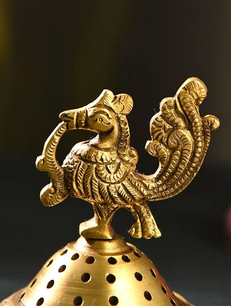 Close view of the peacock on the pierced dome lid