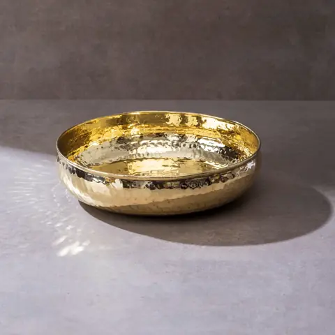 The brass bowl on a grey surface