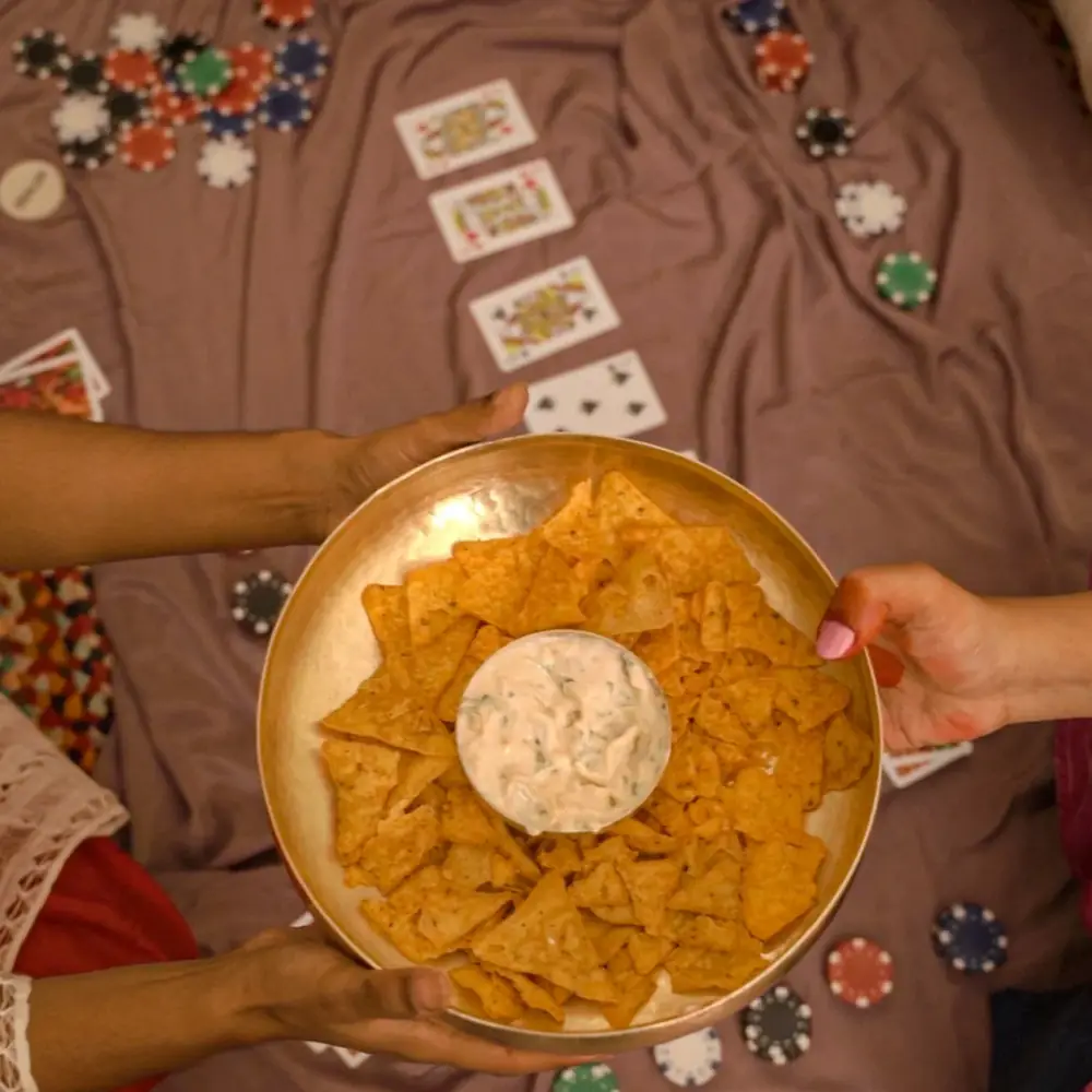 Hands holding the bowl of snacks