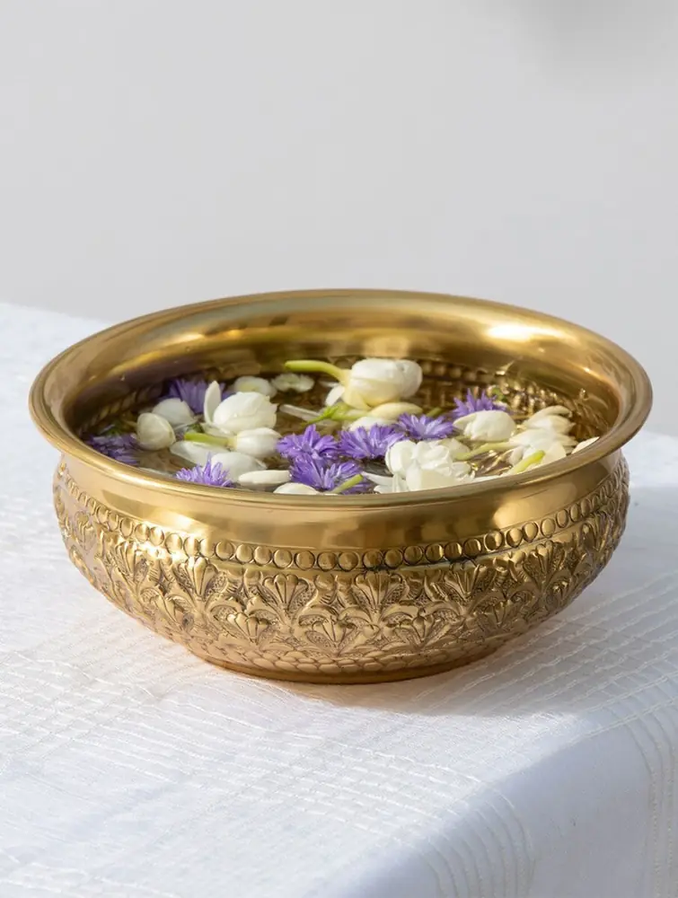 Brass urli filled with floating flowers