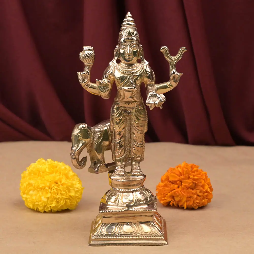 Brihaspati bronze idol standing on its dais with marigolds