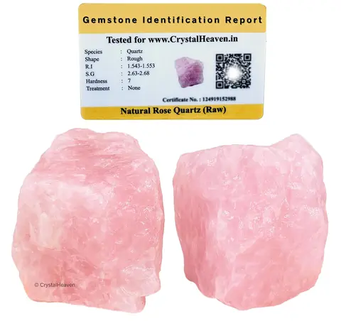Two raw rose quartz pieces beside an identification card