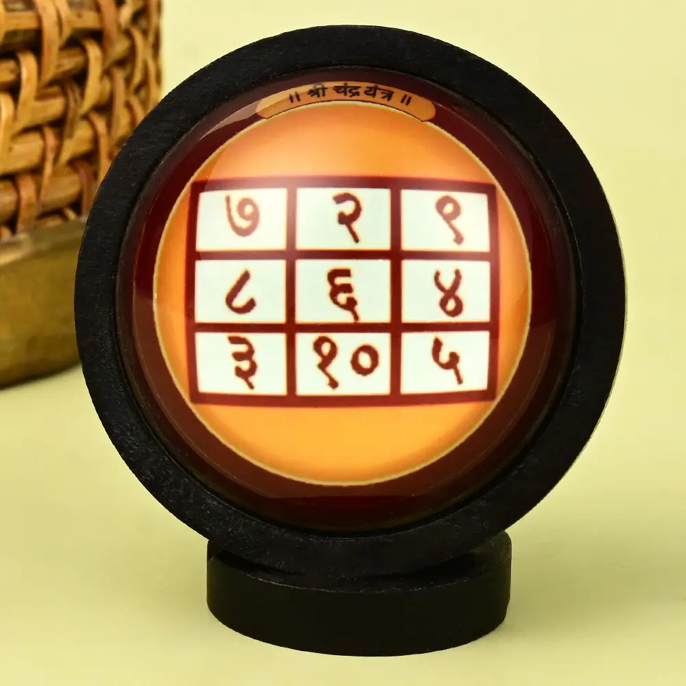 Chandra yantra grid in a round wooden frame on a stand