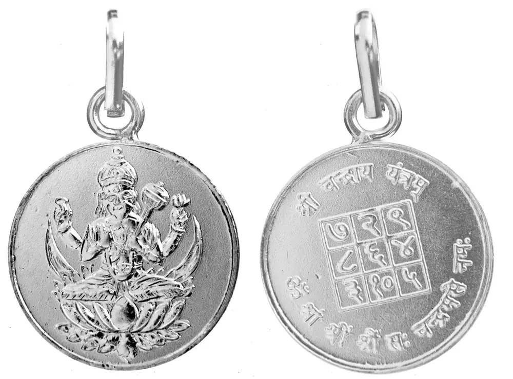 Front and reverse of a round silver Chandra pendant with its yantra