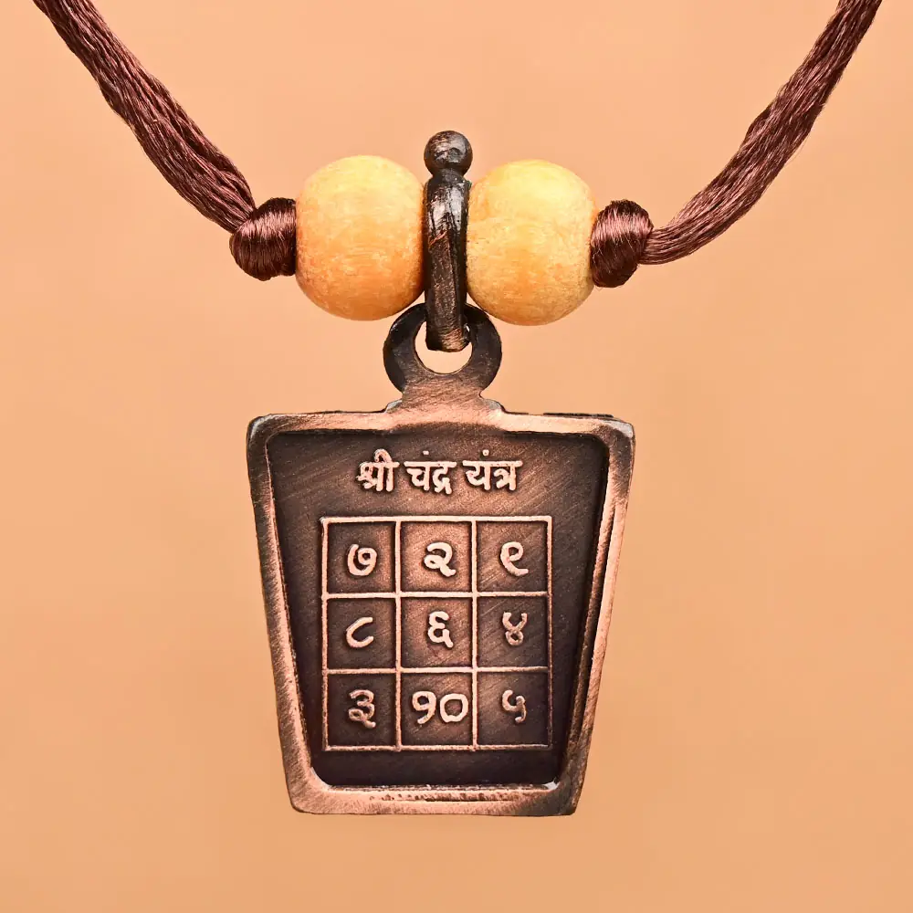 Chandra yantra side of the copper locket on a thread