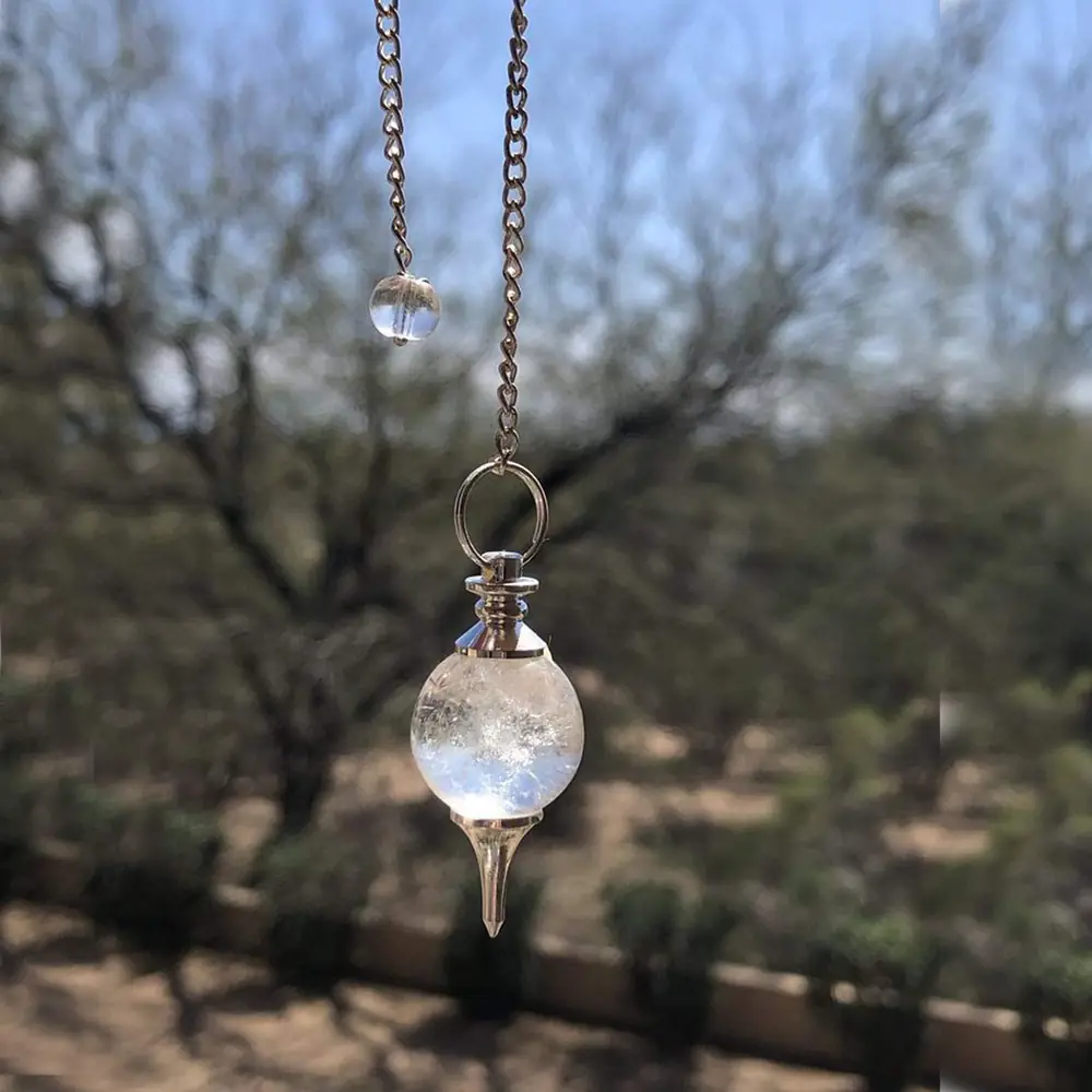 The pendulum hanging outdoors against branches