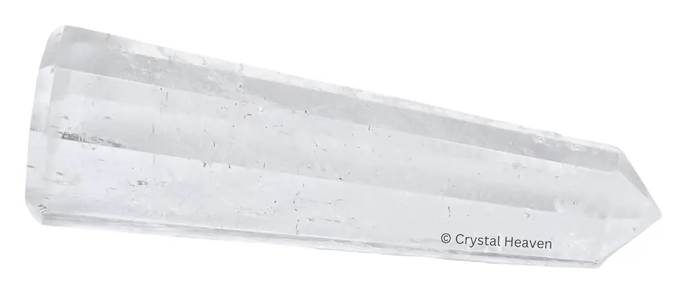 Polished clear quartz tower lying on white
