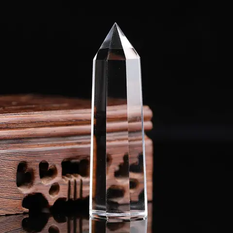 A clear quartz wand against a dark background