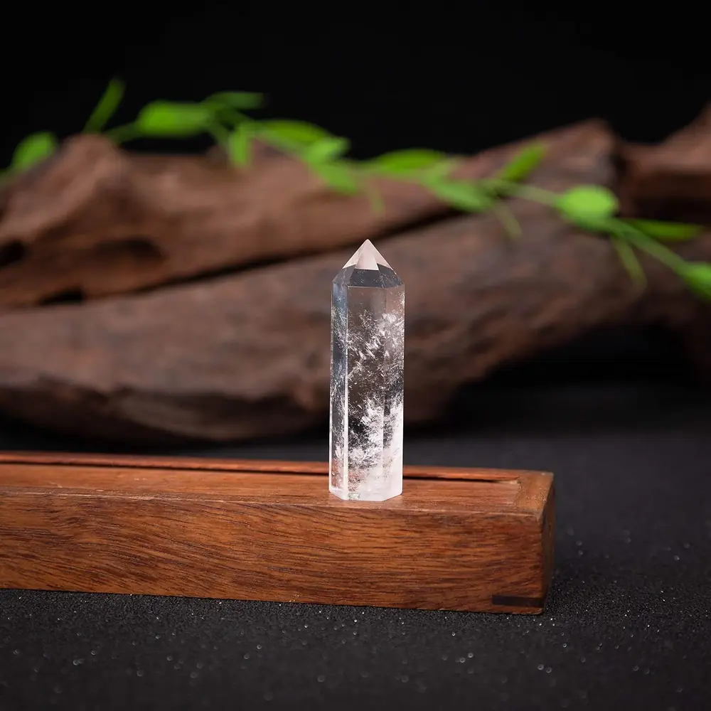 A small quartz wand standing on a wooden block
