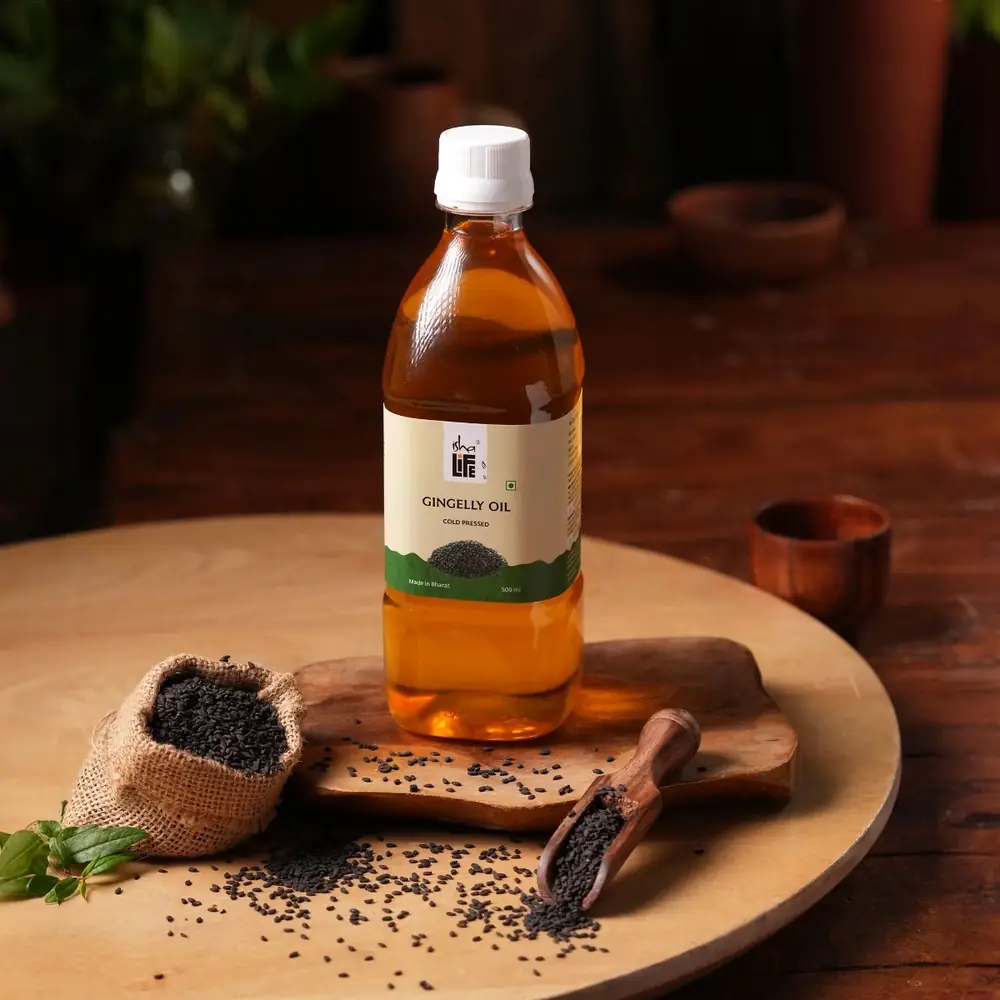 Gingelly oil bottle with a wooden bowl on a table