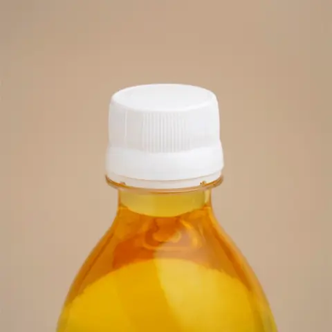 Close view of the bottle cap and oil