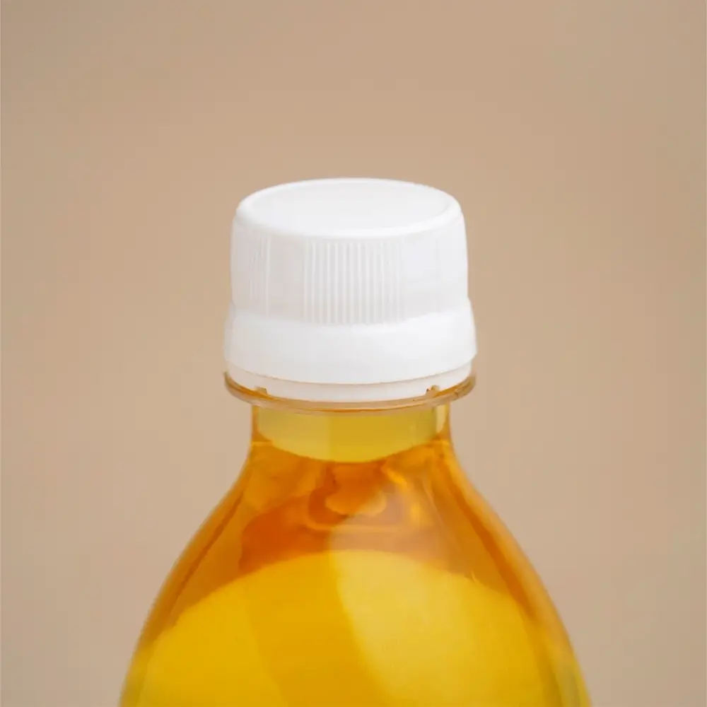 Close view of the bottle cap and oil