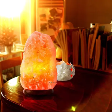 The salt lamp on white, unlit, with its wooden base