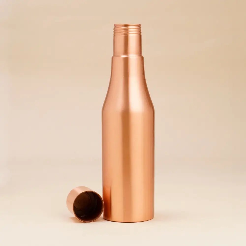 Bottle with its screw cap taken off and placed beside it