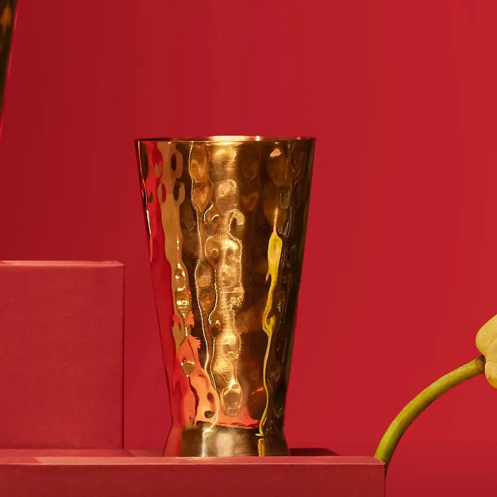 A copper glass on a red background