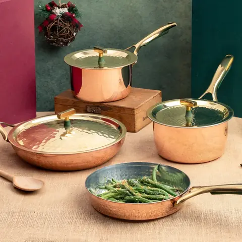 The copper set shown beside green beans cooking in a pan