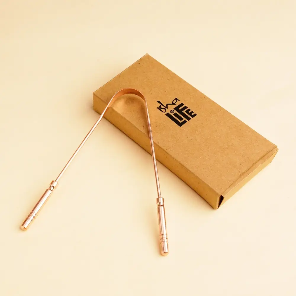 Tongue cleaner leaning on its kraft box