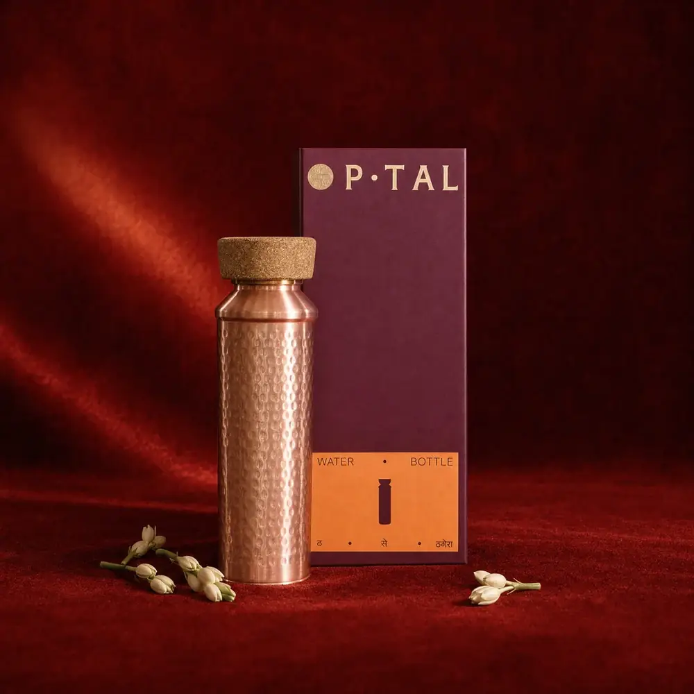 The bottle standing in front of its gift box on red cloth