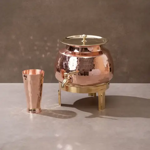 The dispenser with the glass on a grey ground