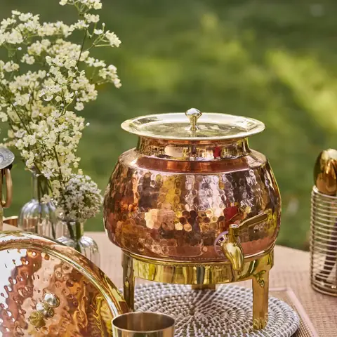 The dispenser on a garden table with flowers