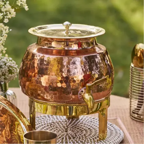 The dispenser on its gold-coloured stand, with the lid on