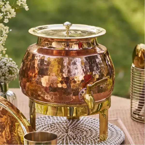 The dispenser on its gold-coloured stand, with the lid on